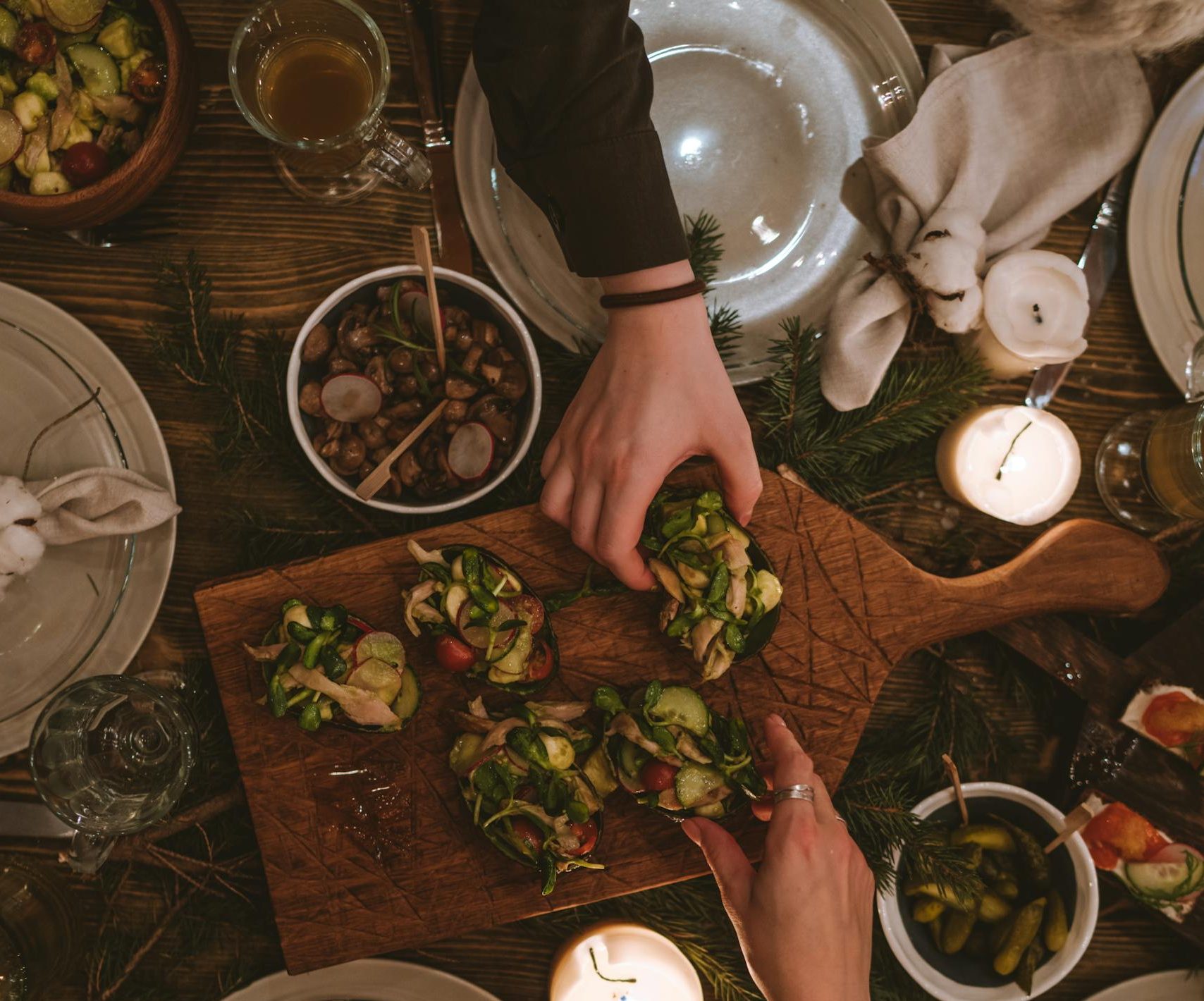 Warm and inviting holiday table with festive decorations and appetizers.